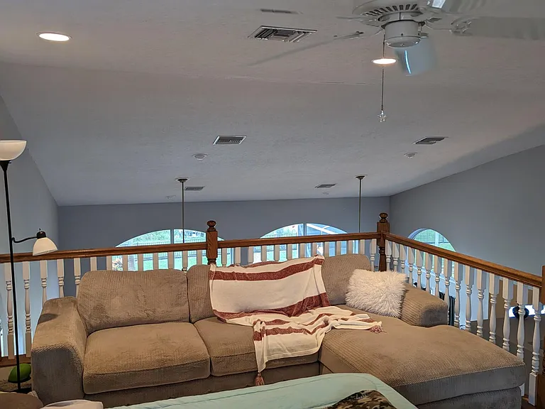 The loft includes lighting, a ceiling fan, a queen size pillow top bed, a plush seating area overlooking the water, a flat screen TV and home office/workstation area.