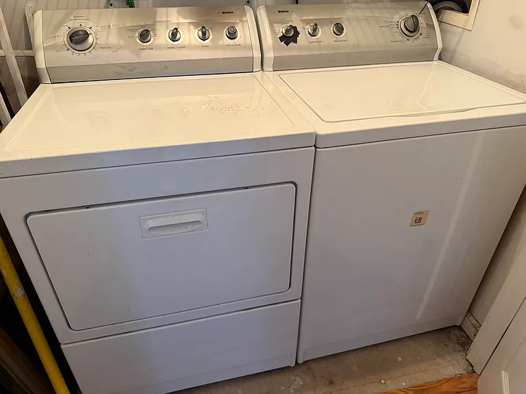 Washer/Dryer with shelf in basement next to living area. Convenient.