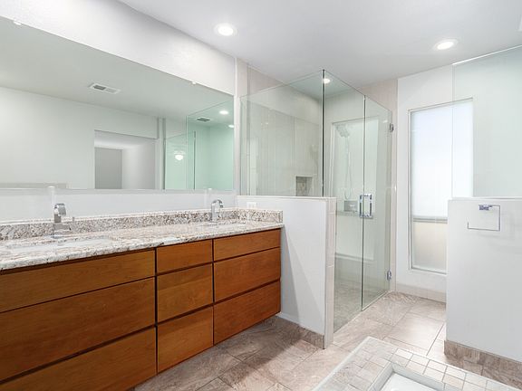Primary Bathroom
Glass-enclosed shower and bright natural light create a clean and spacious feel in the primary bath.