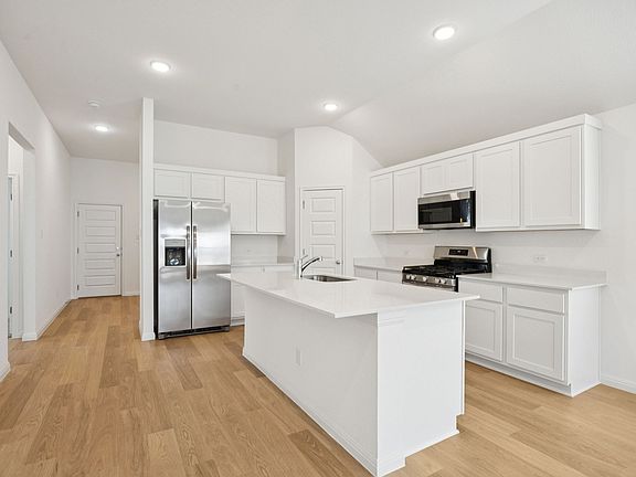 Kitchen in the Redbud home plan by Trophy Signature Homes - REPRESENTATIVE PHOTO