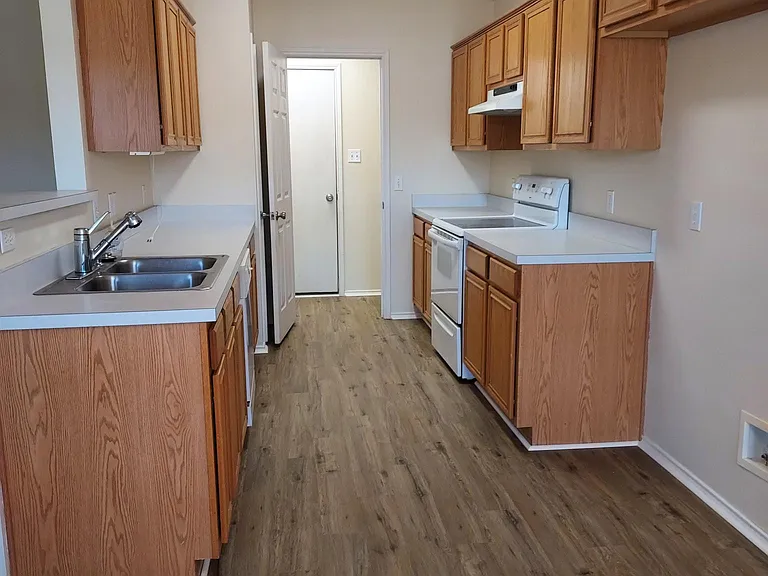 Kitchen with door open to utility area