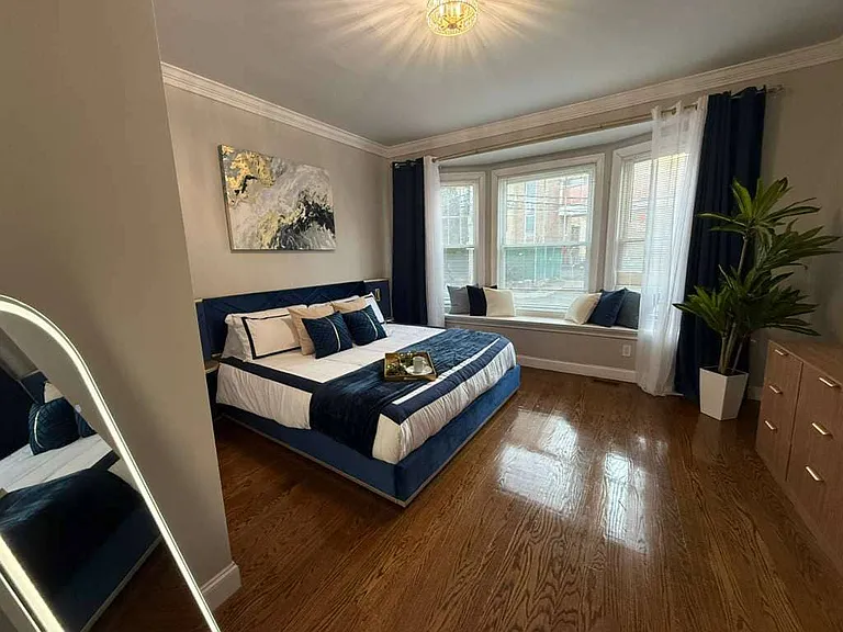 Master bedroom with king size bed with LED lighting and large bay window