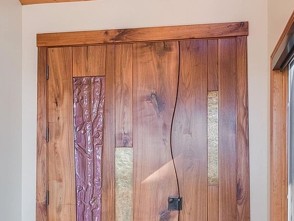 Custom glass and metal walnut front door.