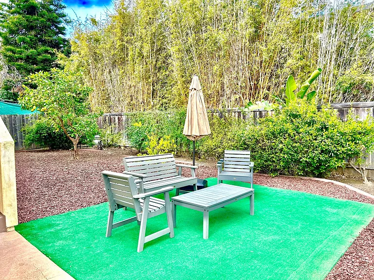 Backyard offers privacy and an outdoor shower