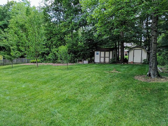 Large backyard with storage sheds