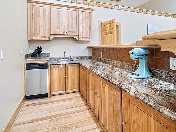 Custom bar with granite countertops and stainless dishwasher
