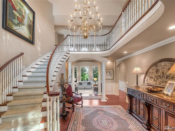 Dramatic grand 2-story entry- style & elegance was added when designing this custom home. Beautiful curved staircase, crown molding, stunning views & overlooking balcony