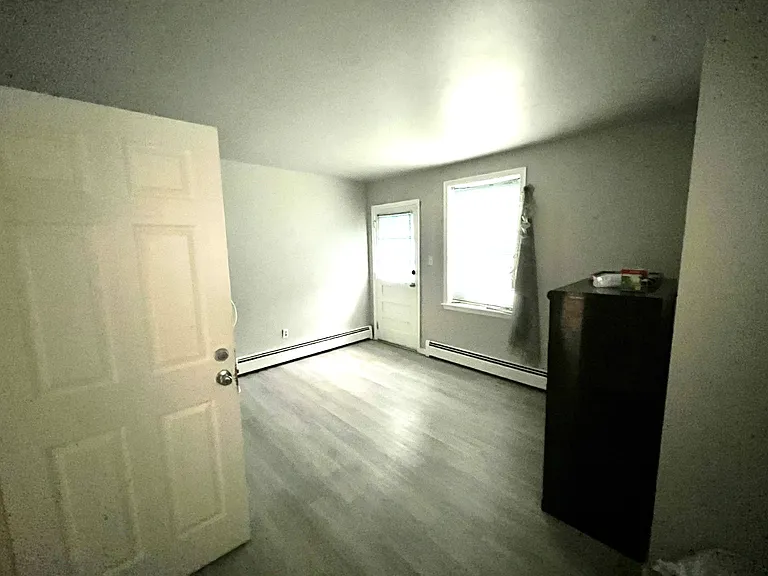 Large room on first level has lots of windows and separate entrance to the back - rented