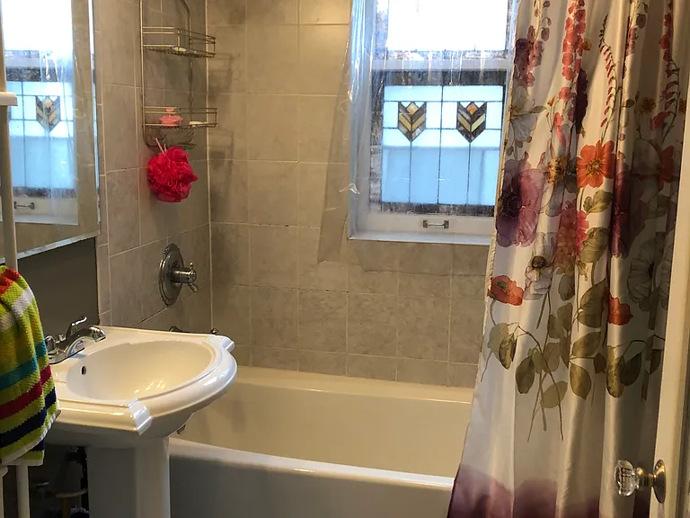 bathroom with original stained glass window