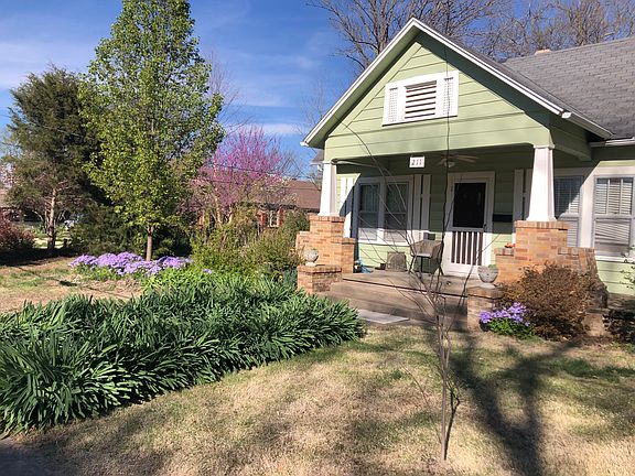 Covered front porch. Spring garden comes alive with Surprise Lilies.