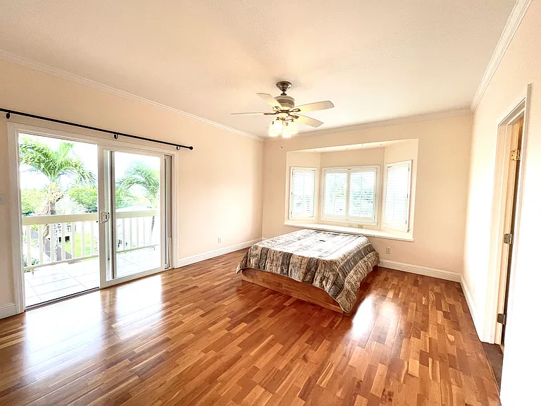 Primary bedroom with bay window bed