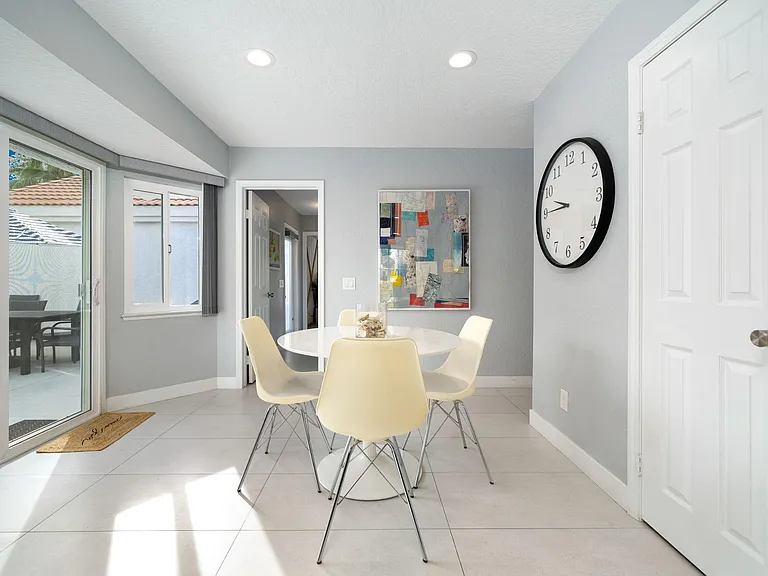 Dinette area with sliders to pool/spa area on left and leading into laundry area & bonus room.