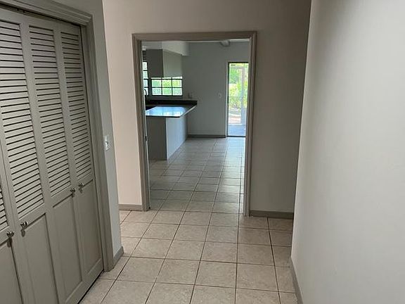 View of kitchen/family room from foyer. Coat closet to left