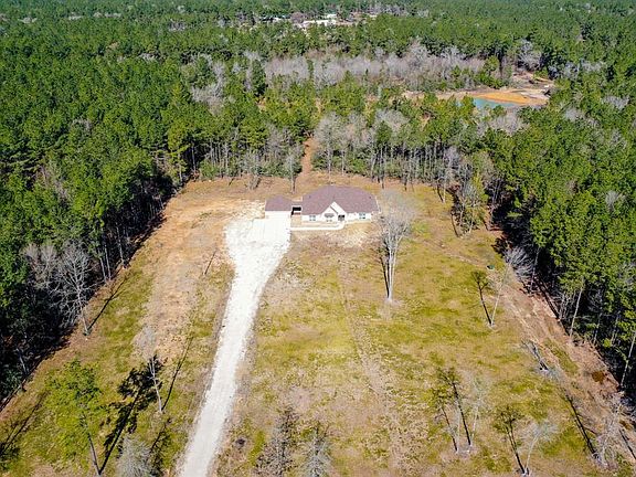 Here is an amazing aerial view of the front of the home & property. The land around the home was cleared to provide TONS of open yard space!