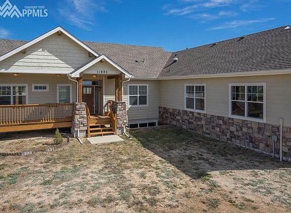 A beautiful home with welcoming porch and stone accents