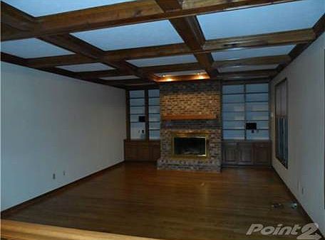 Family room with Gleaming Hardwood Floors and Woodburing Fireplace