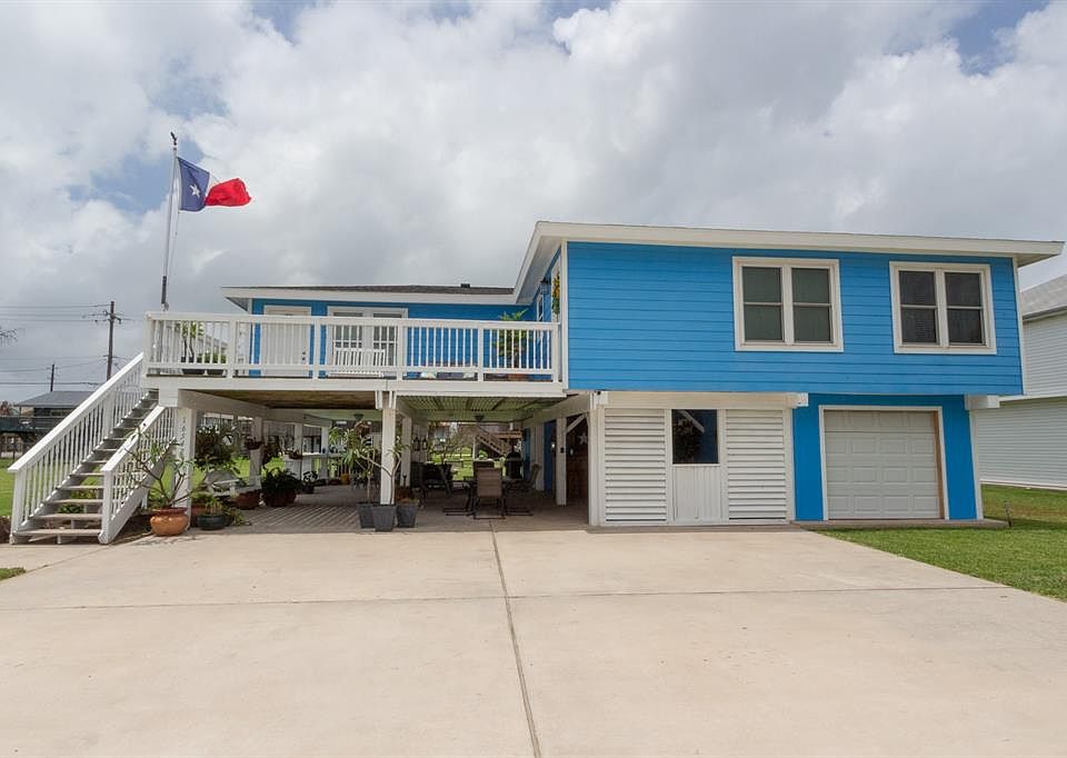 Take a look at this wonderful property....nice deck off of the front and so much downstairs entertaining space with fabulous breezes. Has an enclosed garage with bathroom (not included in sq footage). The lot next door comes with this property at a g