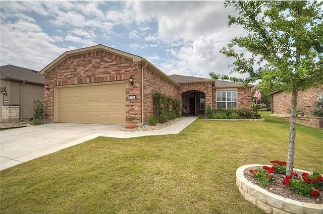 Handsome landscaping makes the full brick exterior even more appealing at this popular Surrey Crest plan which was built with the 4 ft. garage extension.