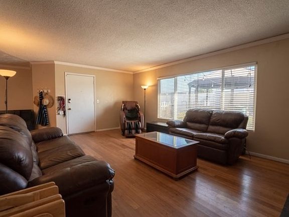 Large living room features a wood burning fireplace. Central heating and air.