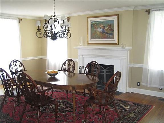 Another view of the dining room showing the brick fireplace. 