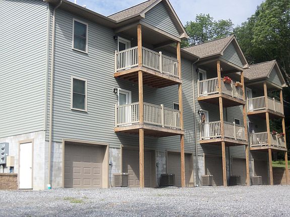 Balcony Porches for each unit with garage and storage for each. Ample parking out here for guests parking.
