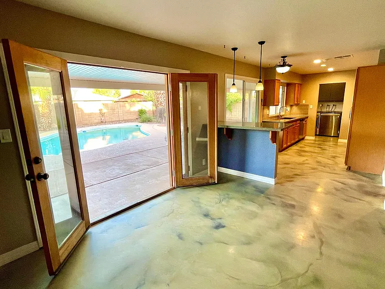 solid wood French doors open to the oasis backyard