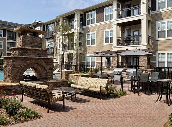 Outdoor Fireplace with Cozy Seating and TV