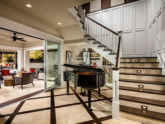 An Elegant Floating Staircase is Featured in the Entry