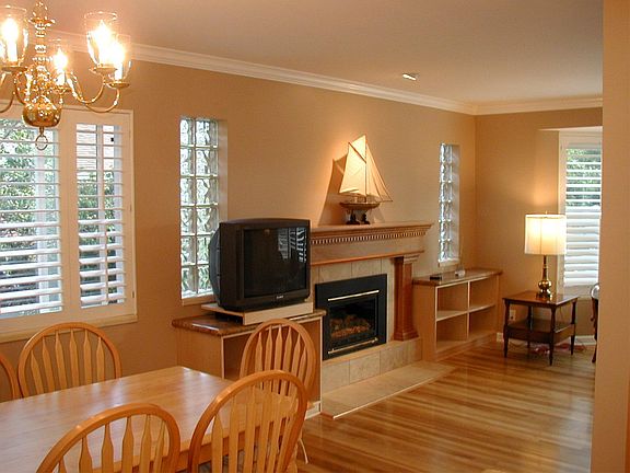 living/dining room with fireplace, bay window