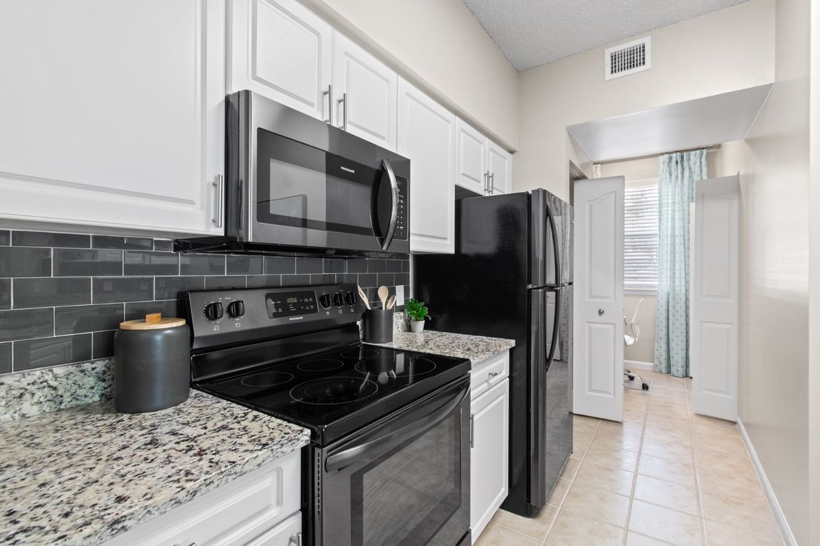 Kitchen with Stainless Steel Appliances at Verona at Boynton Beach Apartments in Boynton Beach, FL 33426