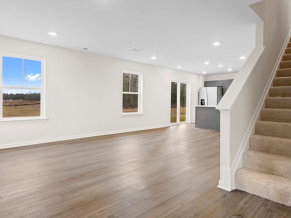 Open 1st floor living room and kitchen in a DRB Homes Glenshaw plan at The Village of College Park.