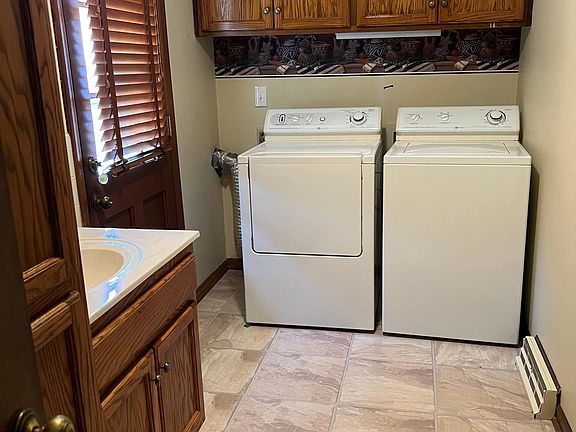 Utility room with washer and dryer and pantry