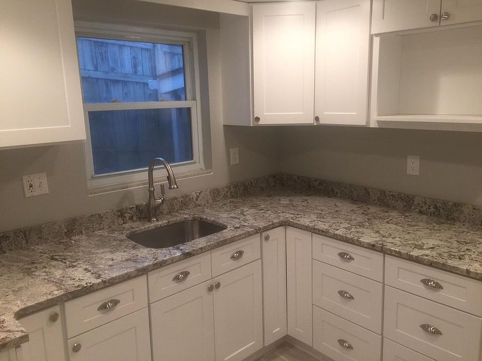 Remodeled kitchen, tile floor, shaker cabinets and alaskan white granite