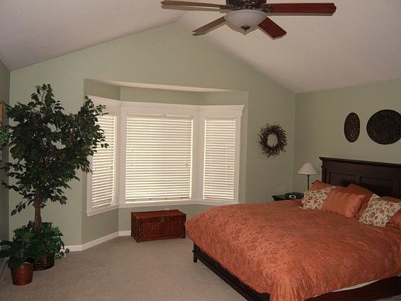 Large master suite with vaulted ceilings and fan