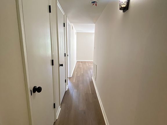 hallway for bathroom, bedroom, and den access