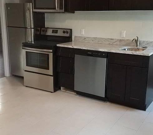 Porcelain tiles in kitchen. Energy saving LED lighting in al