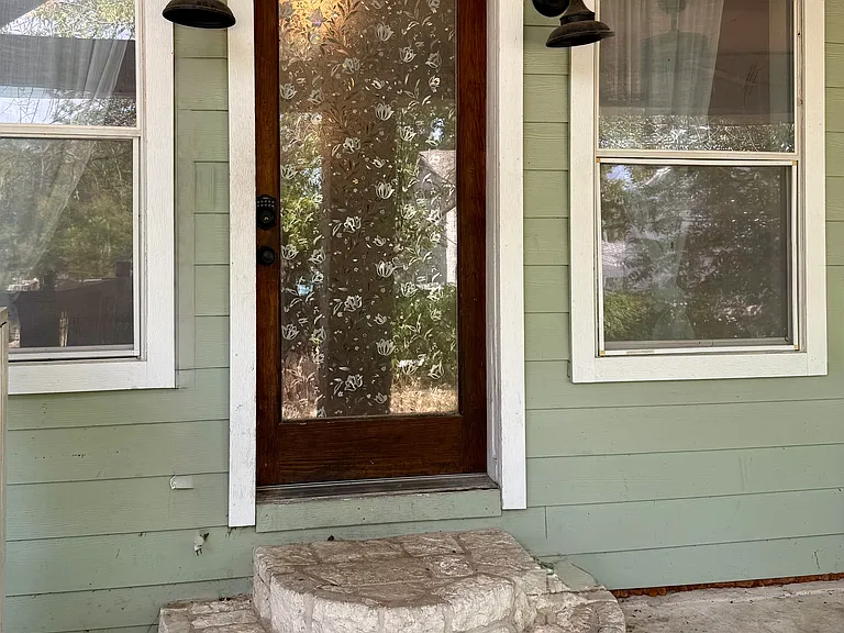 The front door! As you walk through the gate in the fence from the driveway (with room for 2 cars, plus plenty of street parking), this is the door that opens into the warm and well-lit living and dining areas.
