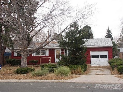 Front of Home with Towering Trees and Evergreens