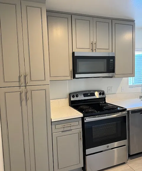 Lots of designer gray cabinetry and pantry