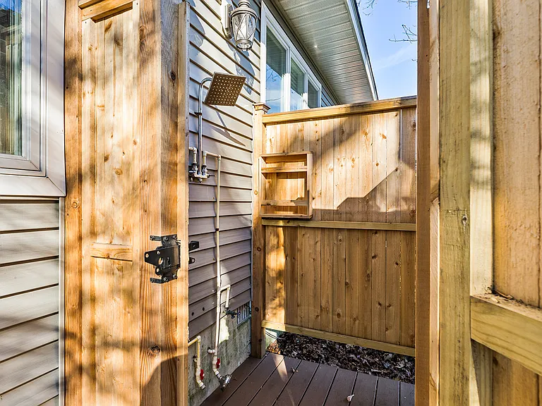 Convenient outdoor shower for rinsing off after trips to the beach or outdoor activities.