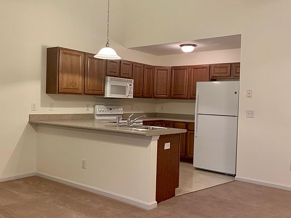 Kitchen includes glass cooktop stove, microwave, dishwasher, garbage disposal, refrigerator