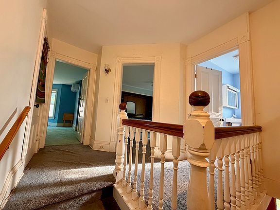 Upstairs landing (L to R: side bedroom, front bedroom, full bath)