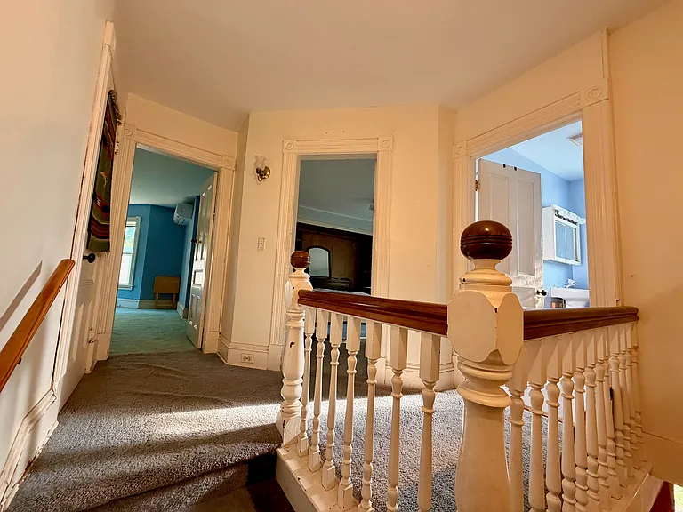 Upstairs landing (L to R: side bedroom, front bedroom, full bath)
