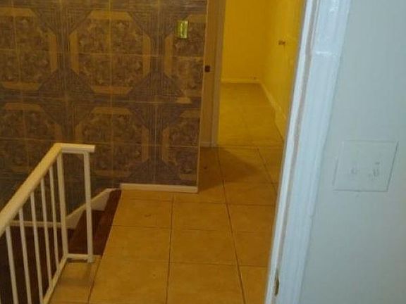 Upstairs hallway (decorative ceramic tile wall and floors)