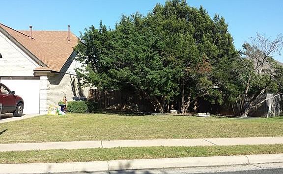Here is more yard space to the right, special RV and/or boat storage behind the big tree, on the other side of privacy fence, with double-wide gates!