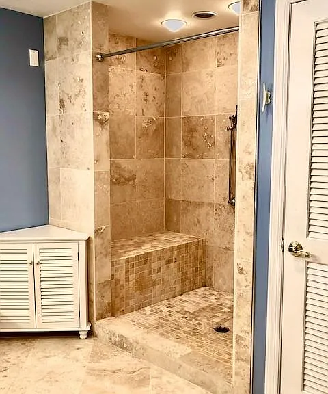 Upgraded shower with bench.