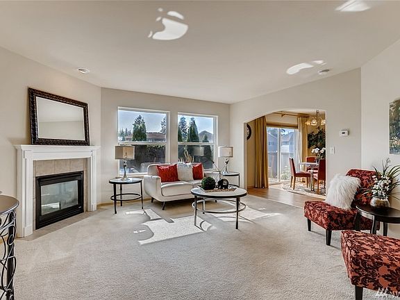 Enjoy the inviting living room with large picture windows and mantled gas fireplace adjoining the dining room and kitchen for easy flow and great entertaining.