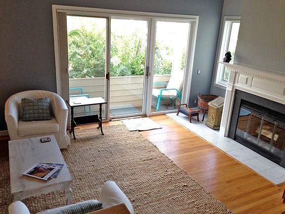 Living Room with Fireplace and Small Balcony