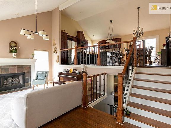 Eat-in kitchen with custom cabinets, granite counter tops, stainless appliances open to great living space with gas fireplace...all with hardwood floors.