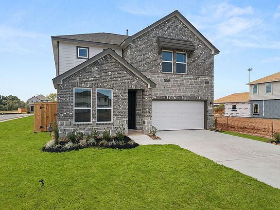 An additional view of your home featuring an aesthetic mix of brick and stone